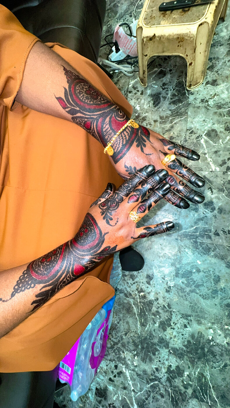 Bold red and black arm henna