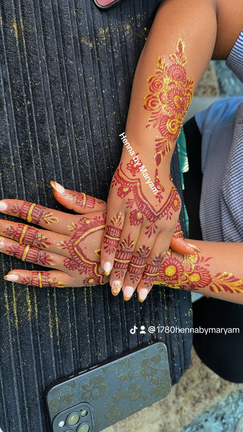 Red and gold glitter hand henna
