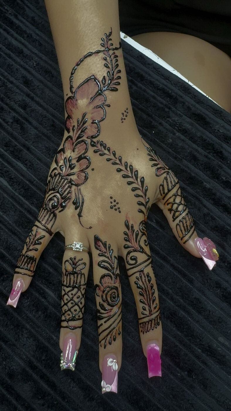 Floral hand henna with pink accents